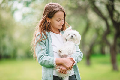 Woman with dog on field