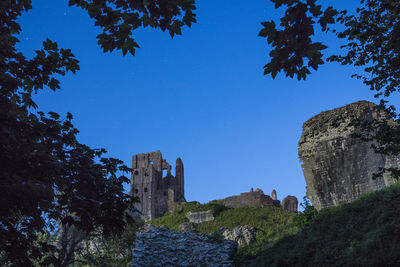 Low angle view of castle against clear blue sky