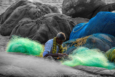 Rear view of man fishing in water