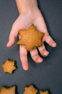 High angle view of human hand holding cookies