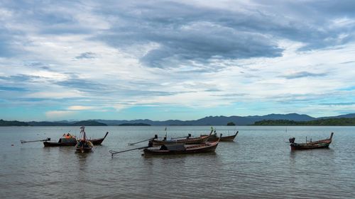 Boats in sea against sky