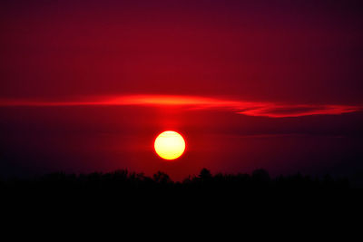 Scenic view of silhouette trees against romantic sky at sunset