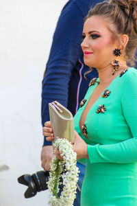 Midsection of woman holding ice cream standing outdoors