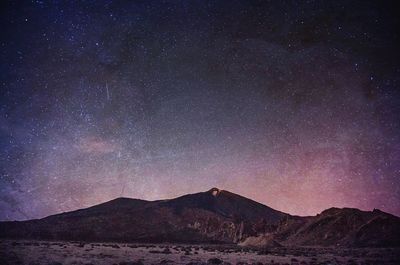 Scenic view of starry sky over mountains