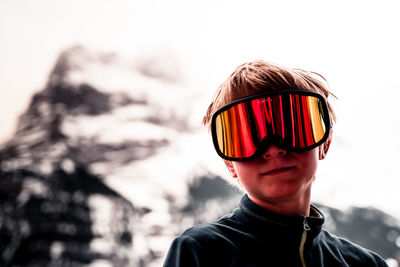 Portrait of young woman wearing sunglasses against sky