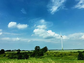 Windmill on field against sky