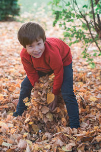 Portrait of boy with autumn leaves