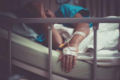 Woman lying on bed in hospital