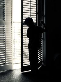 Boy standing at doorway