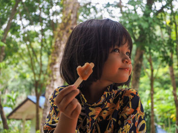 Portrait of cute girl holding plant
