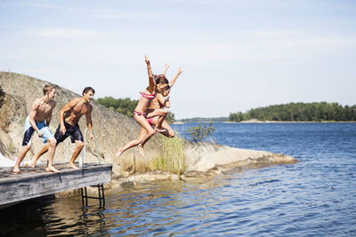 Teenagers jumping into water