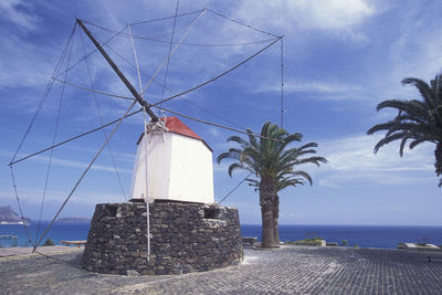 Traditional windmills against sky