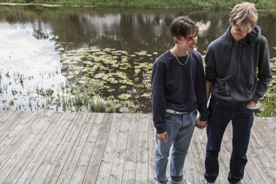 Two teenage boys holding hands