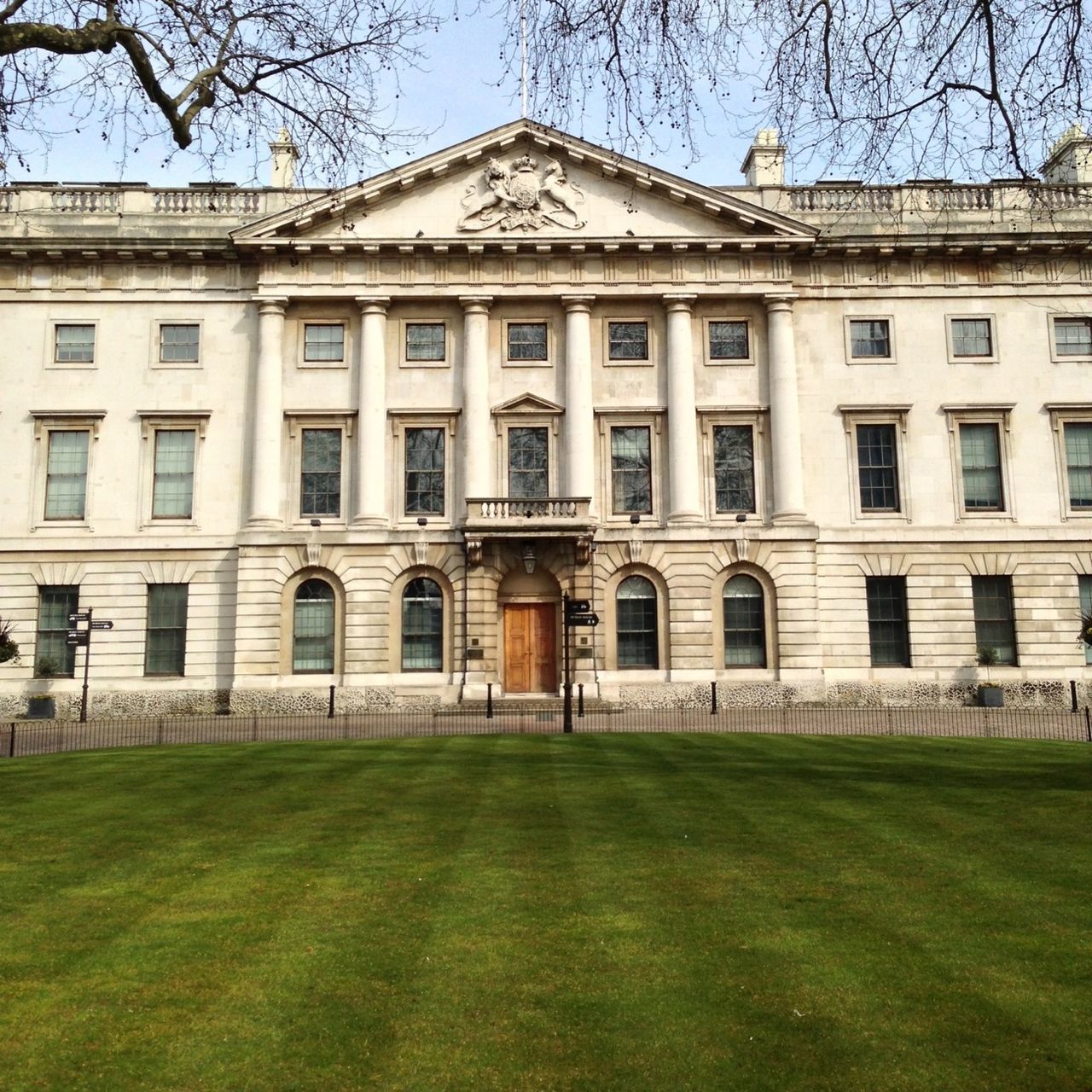 architecture, building exterior, built structure, grass, lawn, window, facade, tree, green color, building, sky, day, bare tree, outdoors, residential building, grassy, city, exterior, no people, arch