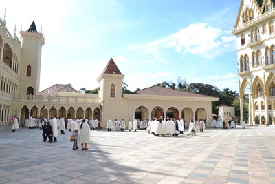 People outside historic building