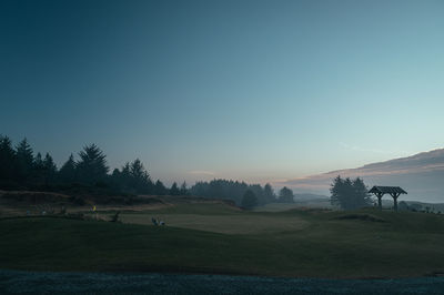 Scenic view of field against sky during sunset