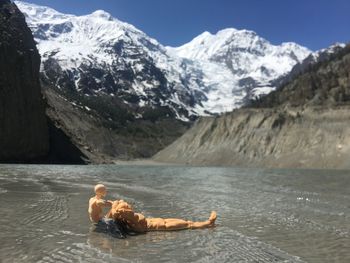 Man lying on snowcapped mountain