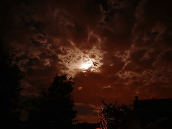 Silhouette of tree against cloudy sky