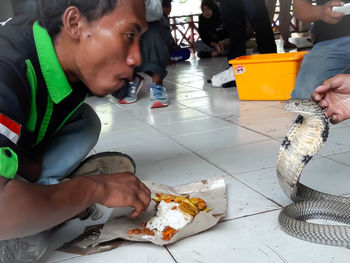 Midsection of people holding food on table