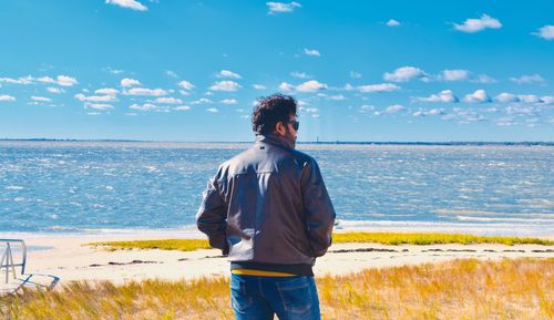 Man looking at sea against sky