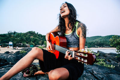 Young woman playing guitar