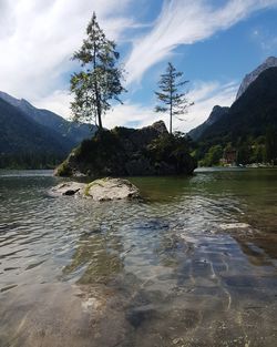 Scenic view of lake by mountains against sky