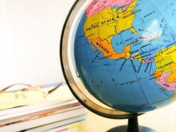 Countries and continents with colorful map on globe with books in the background. education concept.