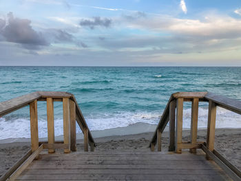 Scenic view of sea against sky from a wooden deck