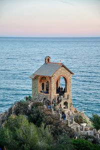 Elevated view of the little chapel of alassio with sea in background