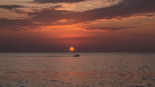 Scenic view of sea against orange sky