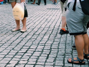 Low section of man standing on zebra crossing