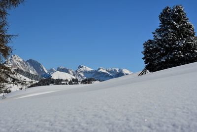 Scenic view of snowcapped mountains against clear sky