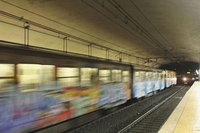 Blurred motion of train at railroad station