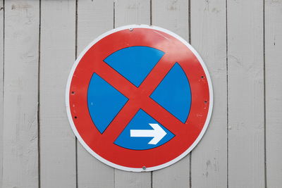 Close-up of no stopping sign on wooden wall