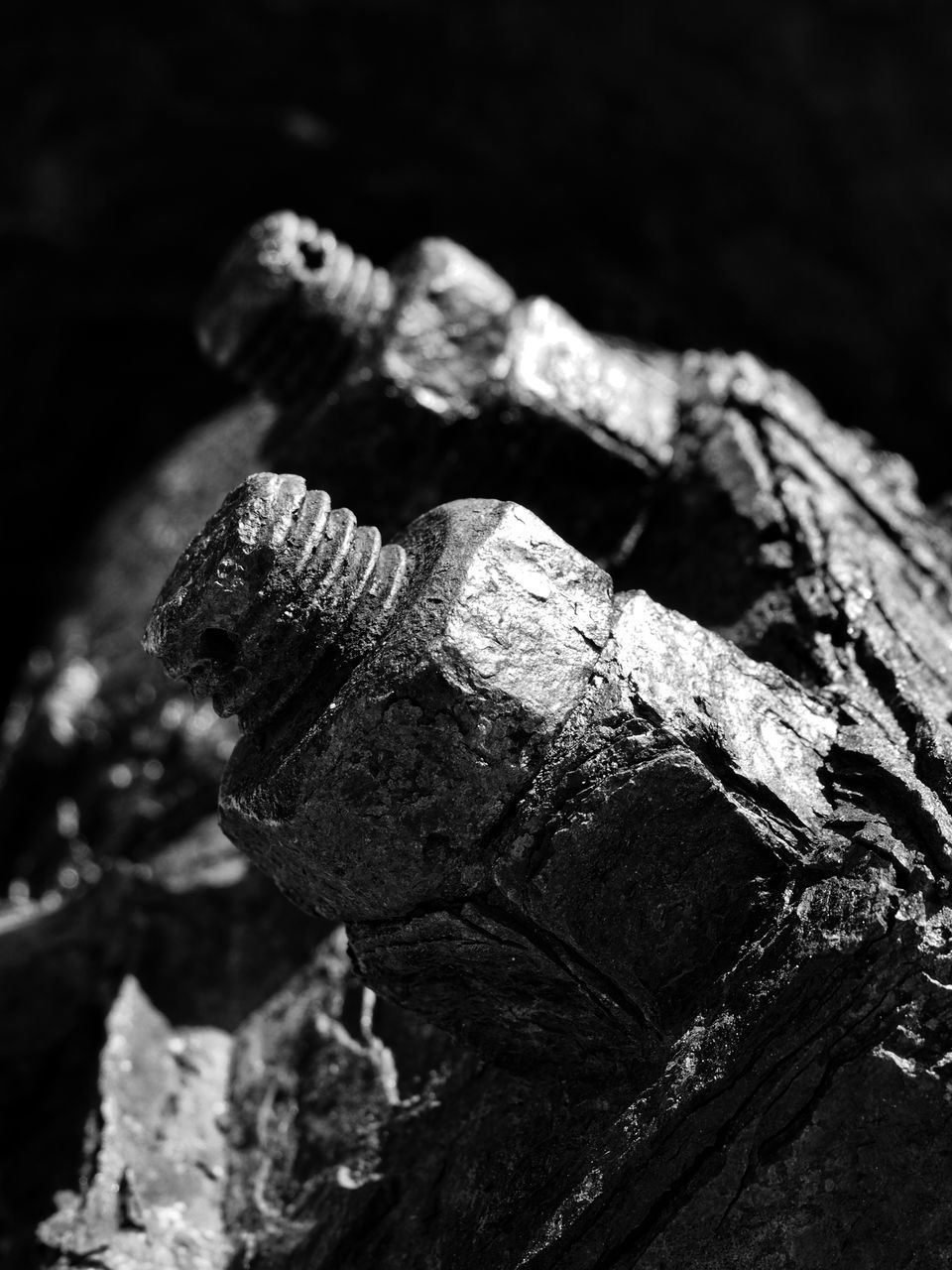 CLOSE-UP OF OLD RUSTY METAL ON WOOD