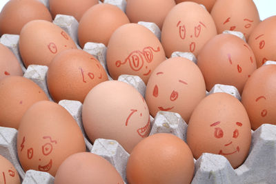 Face drawn on eggs in carton