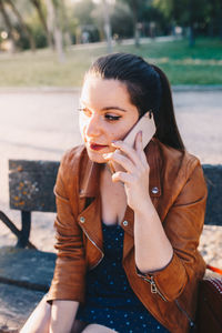 Portrait of young woman sitting outdoors
