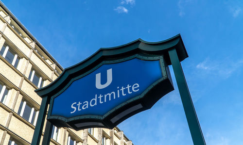 Low angle view of text on building against sky