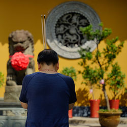Rear view of boy looking at camera