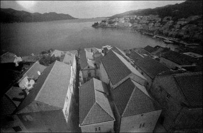 High angle view of buildings by sea against sky