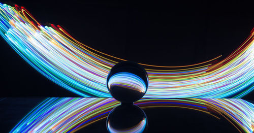 Digital composite image of light painting against black background