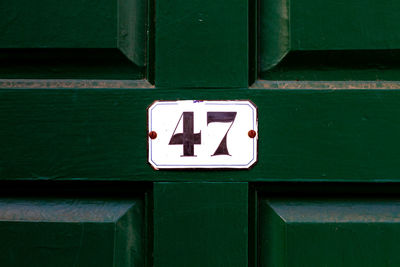 Close-up of information sign against blue door