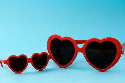 Close-up of sunglasses against blue sky