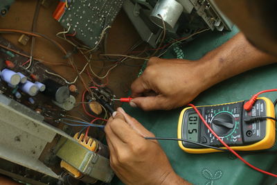 Close-up of man repairing computer chip
