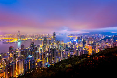 Panoramic view of illuminated buildings against sky at night