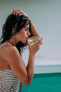 Midsection of a beautiful young woman drinking water