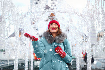 Beautiful woman wearing knit hat and sweater standing outdoors