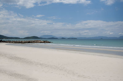 View of beach against cloudy sky