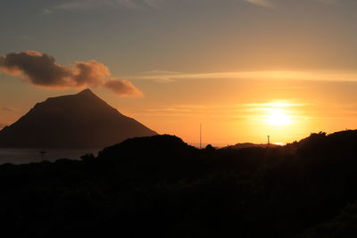 Scenic view of silhouette mountains against sky during sunset