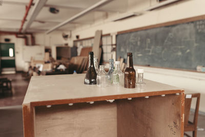 Bottles on desk in workshop